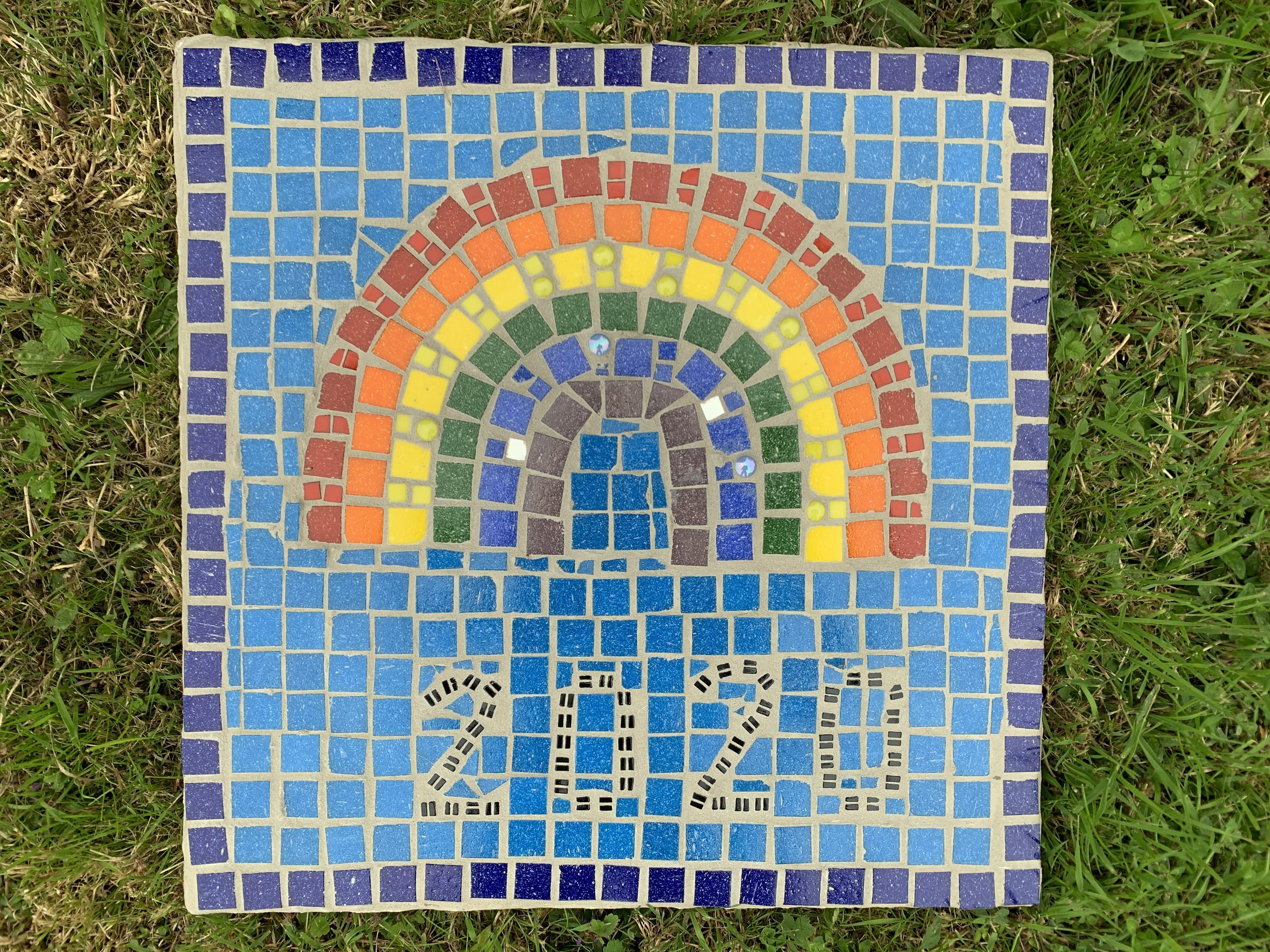 Children in school have worked together to complete this amazing mosaic rainbow!